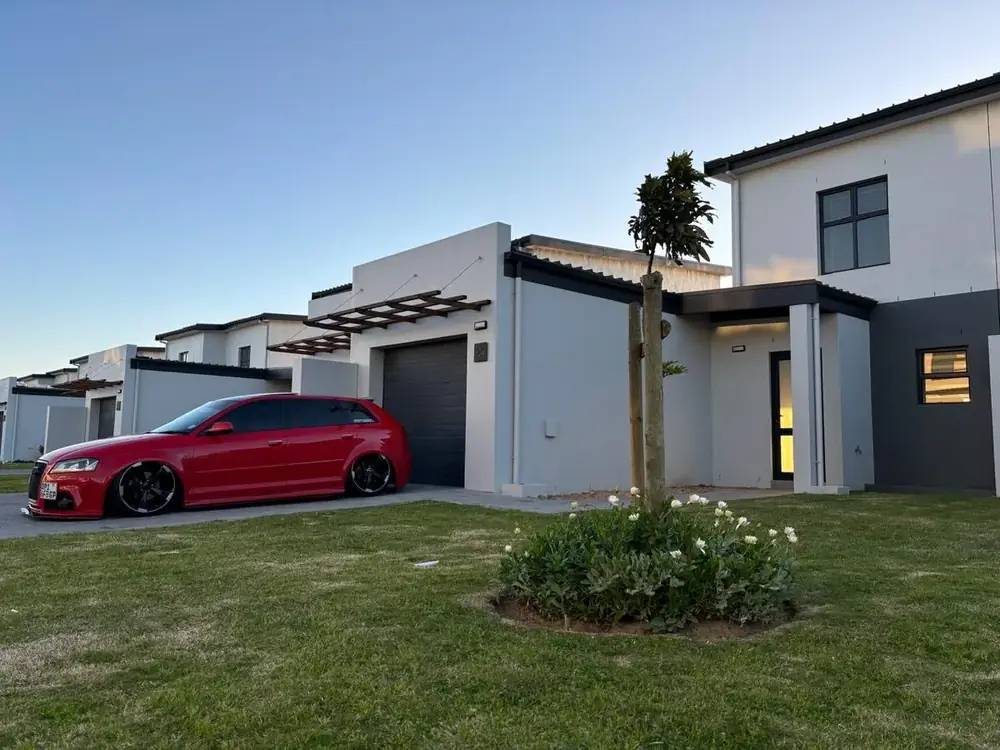 Modern home with red car